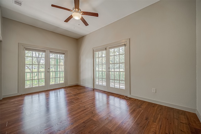 unfurnished room featuring wood-type flooring, ceiling fan, french doors, and a wealth of natural light