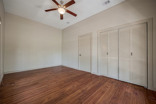 unfurnished bedroom with ceiling fan and dark hardwood / wood-style flooring