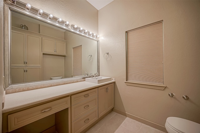 bathroom featuring vanity, tile patterned flooring, and toilet