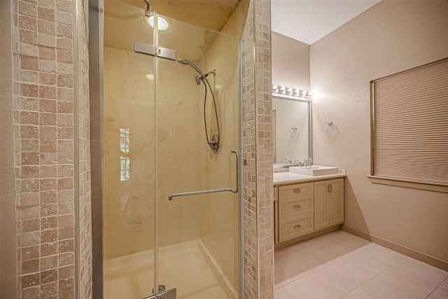 bathroom with vanity, a shower with shower door, and tile patterned floors