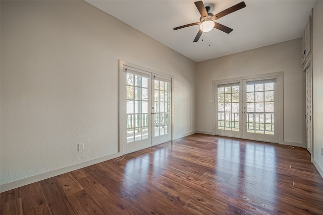 spare room with ceiling fan, dark hardwood / wood-style flooring, and a wealth of natural light