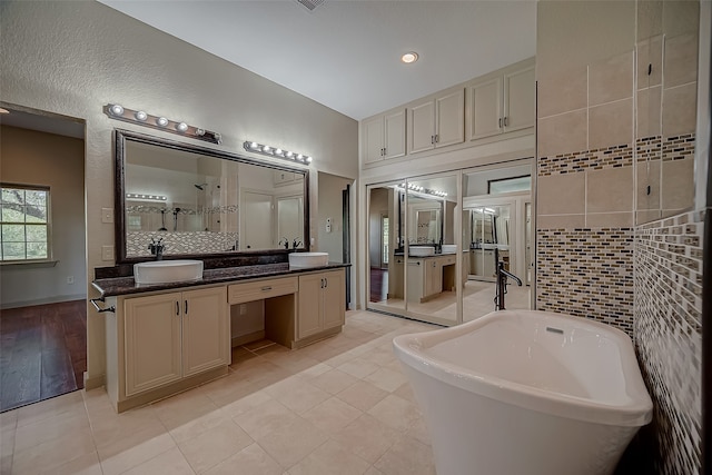 bathroom with tile patterned floors, independent shower and bath, and vanity