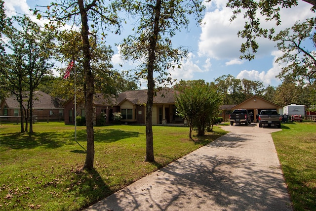 ranch-style house featuring a carport, a garage, and a front yard