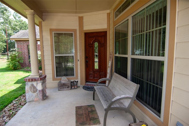 entrance to property featuring a lawn