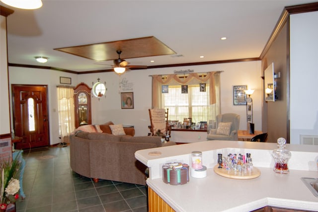 living area with recessed lighting, dark tile patterned flooring, ceiling fan, and ornamental molding