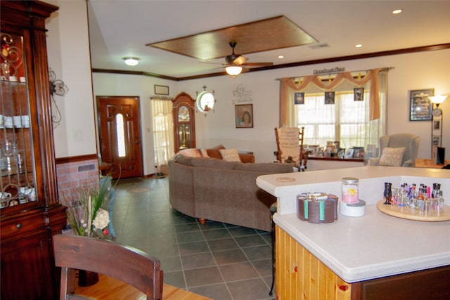 living room with recessed lighting, crown molding, ceiling fan, and dark tile patterned flooring