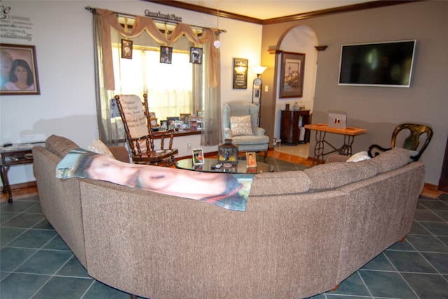 living room featuring ornamental molding and dark tile patterned floors