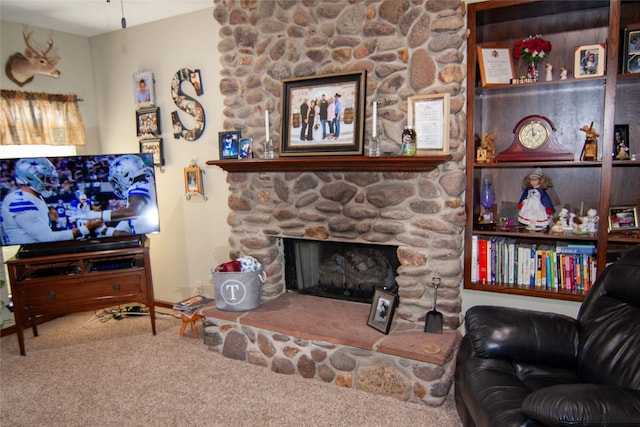 carpeted living room with a stone fireplace