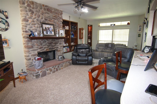 carpeted living area featuring a fireplace and ceiling fan