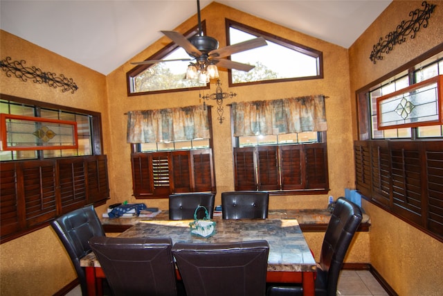 tiled dining room with lofted ceiling, ceiling fan, and a healthy amount of sunlight