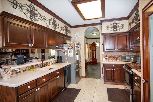 kitchen featuring tasteful backsplash, sink, light tile patterned flooring, appliances with stainless steel finishes, and crown molding