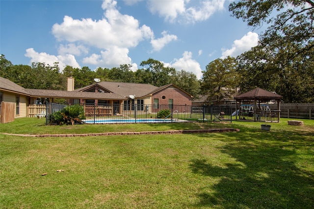 view of yard featuring a fenced in pool and a gazebo