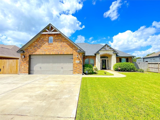 view of front of property featuring a garage and a front lawn