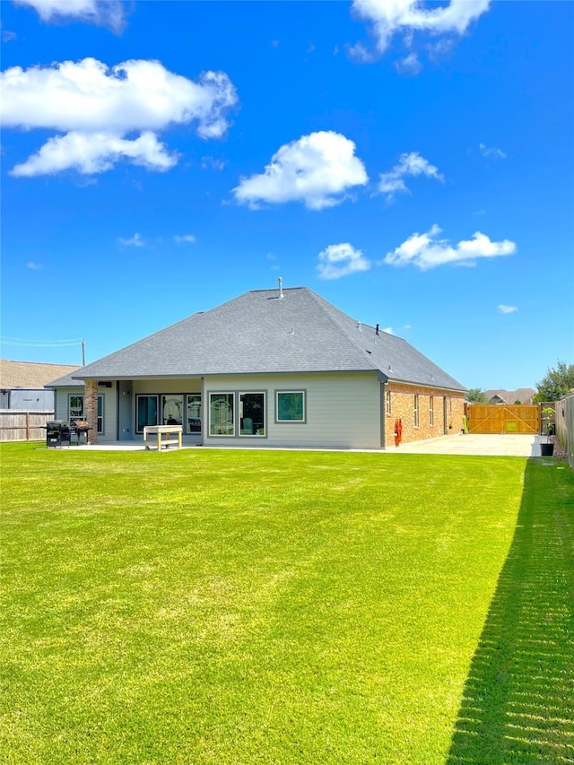 308 Creekside Ln, Lake Jackson, TX 77566 - rear view of house featuring a patio area, roof with shingles, and brick siding