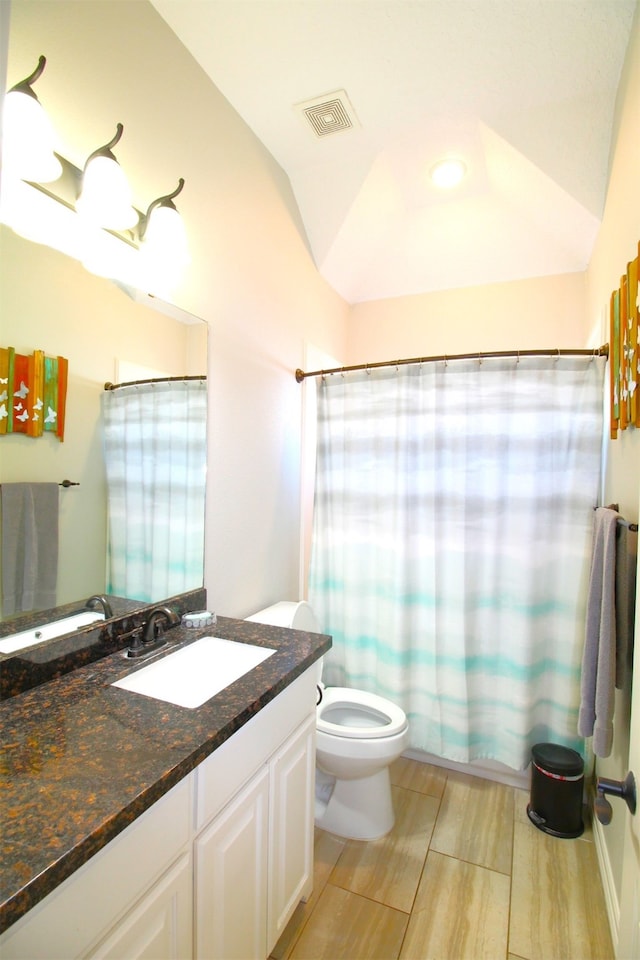 full bathroom with shower / tub combo, vanity, lofted ceiling, hardwood / wood-style flooring, and toilet