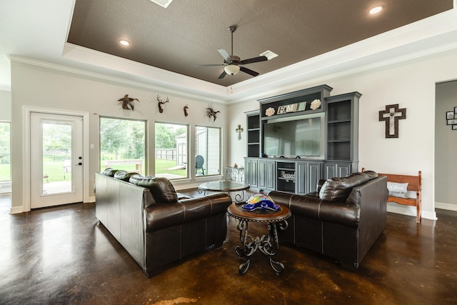 308 Creekside Ln, Lake Jackson, TX 77566 - living room with concrete floors, a tray ceiling, crown molding, ceiling fan, and a textured ceiling