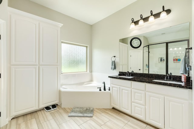 308 Creekside Ln, Lake Jackson, TX 77566 - full bathroom featuring a garden tub, a stall shower, and double vanity