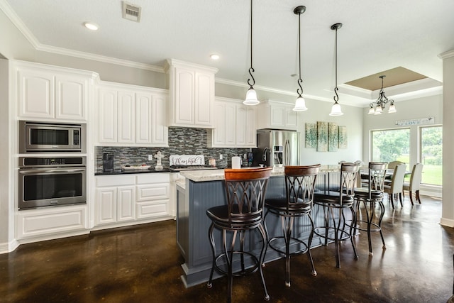308 Creekside Ln, Lake Jackson, TX 77566 - kitchen with stainless steel appliances, crown molding, tasteful backsplash, white cabinetry, and recessed lighting