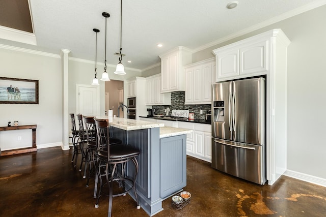 308 Creekside Ln, Lake Jackson, TX 77566 - kitchen featuring appliances with stainless steel finishes, decorative backsplash, baseboards, a center island with sink, and ornamental molding