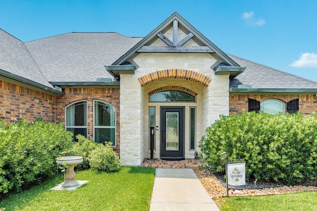 308 Creekside Ln, Lake Jackson, TX 77566 - entrance to property with a shingled roof, stone siding, and brick siding