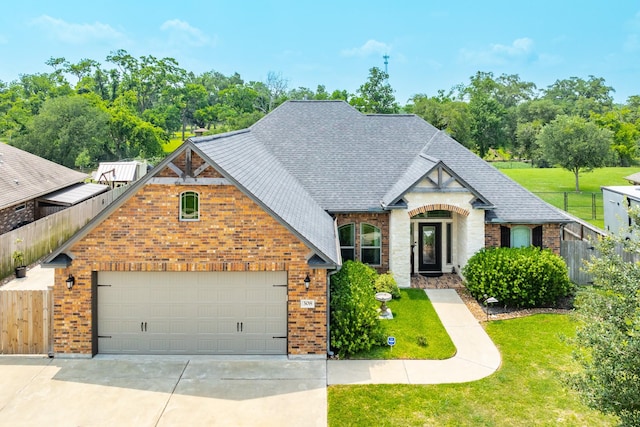 308 Creekside Ln, Lake Jackson, TX 77566 - view of front of home with driveway, brick siding, roof with shingles, and a garage