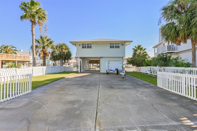 view of front of property with a front yard, a garage, and a carport