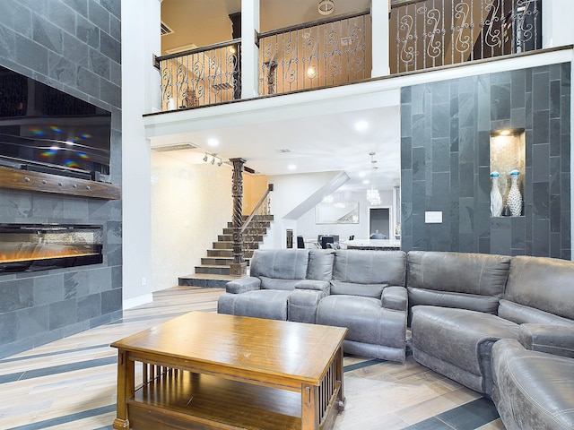 living room featuring a fireplace and a towering ceiling