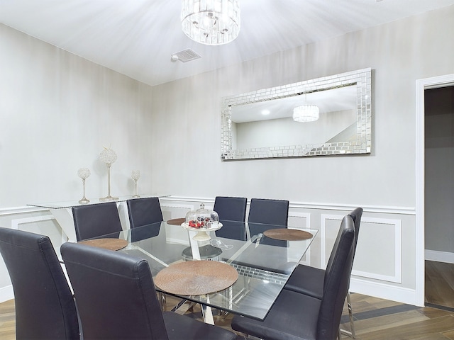 dining room featuring wood-type flooring and a notable chandelier