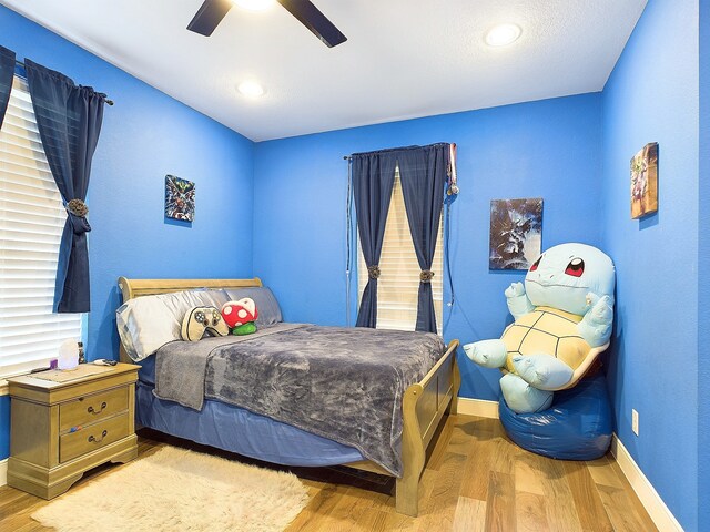 bedroom featuring light hardwood / wood-style floors and ceiling fan