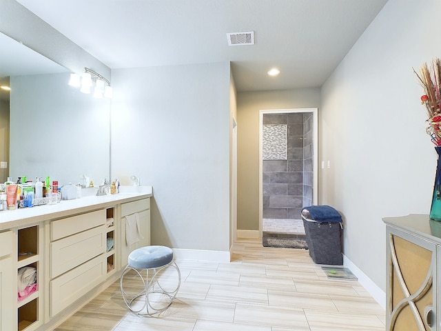 bathroom featuring vanity and a tile shower