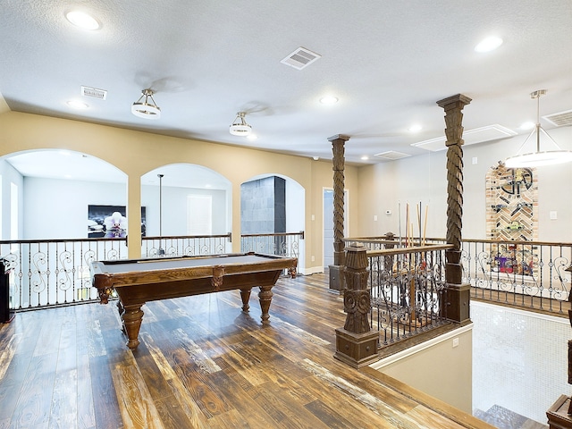 rec room featuring wood-type flooring, a textured ceiling, ornate columns, and pool table