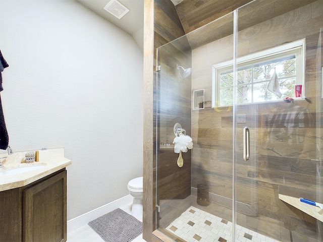 bathroom featuring vanity, lofted ceiling, an enclosed shower, toilet, and tile patterned floors