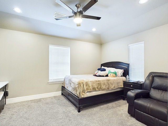 carpeted bedroom with vaulted ceiling and ceiling fan