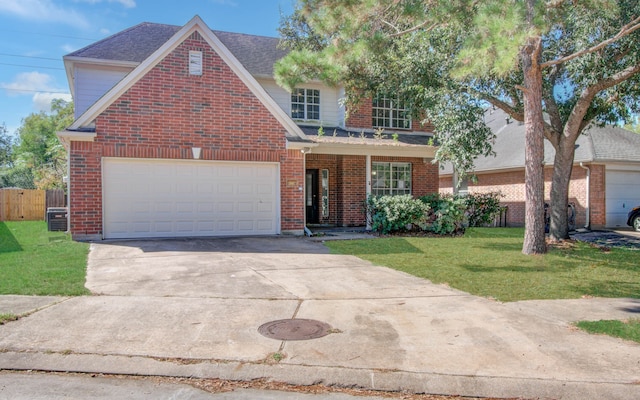 view of front property featuring a garage, central AC, and a front lawn