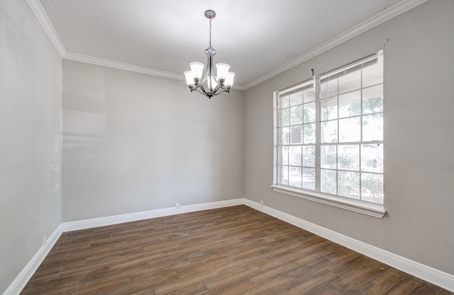 unfurnished room featuring an inviting chandelier, crown molding, and dark hardwood / wood-style flooring