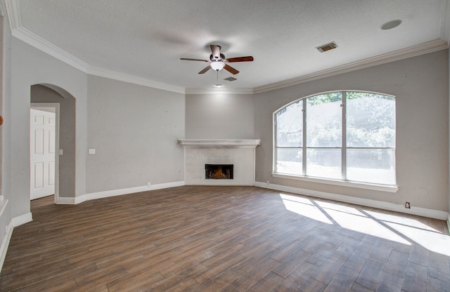 unfurnished living room featuring a textured ceiling, ornamental molding, dark hardwood / wood-style floors, and ceiling fan