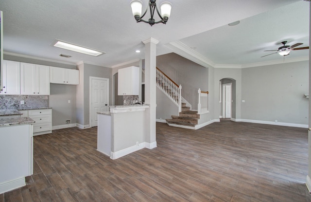 kitchen featuring ceiling fan with notable chandelier, backsplash, dark hardwood / wood-style floors, and white cabinets