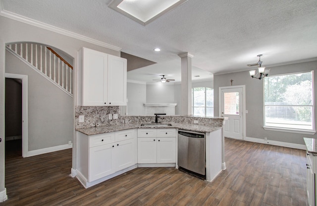 kitchen with ceiling fan with notable chandelier, white cabinetry, kitchen peninsula, and stainless steel dishwasher