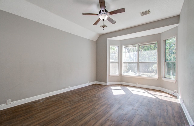 unfurnished room with vaulted ceiling, ceiling fan, and dark hardwood / wood-style flooring