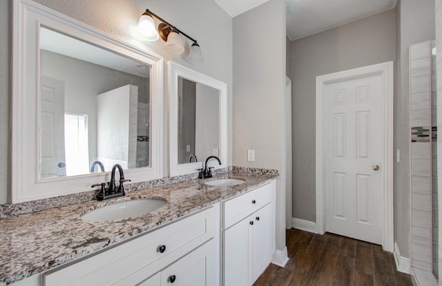 bathroom with hardwood / wood-style floors and vanity