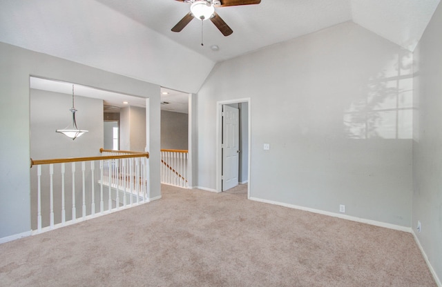 carpeted spare room with lofted ceiling and ceiling fan