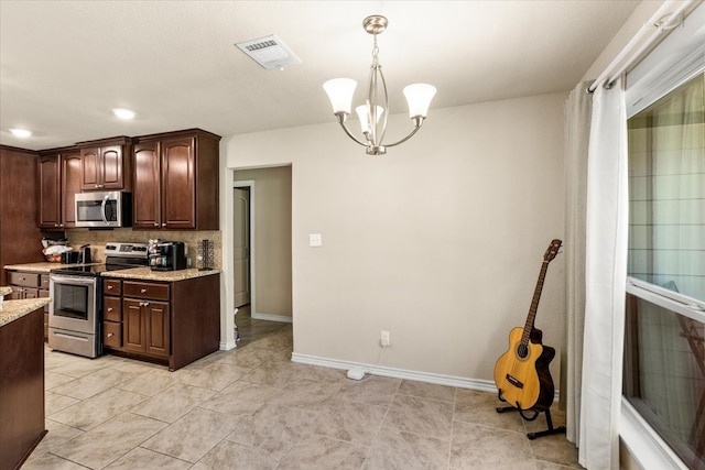 kitchen featuring stainless steel appliances, an inviting chandelier, pendant lighting, decorative backsplash, and dark brown cabinets