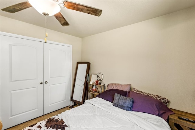 bedroom with a closet, ceiling fan, and hardwood / wood-style flooring