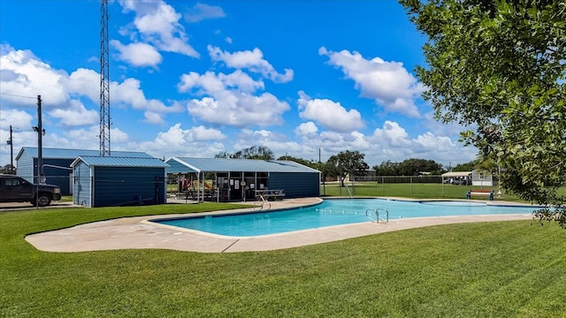 view of pool with a patio and a lawn