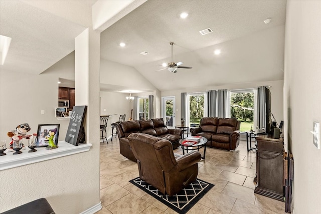 living room with ceiling fan, light tile patterned floors, and lofted ceiling