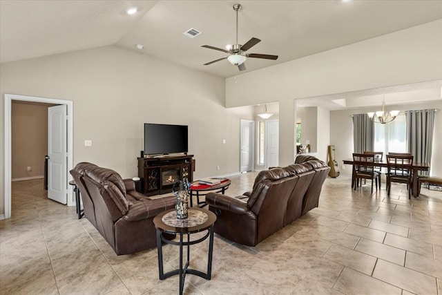 living room with a fireplace, light tile patterned floors, ceiling fan with notable chandelier, and high vaulted ceiling