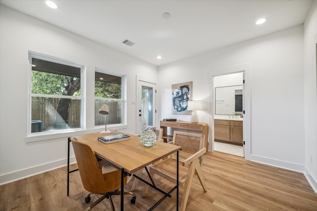 dining space with light hardwood / wood-style flooring