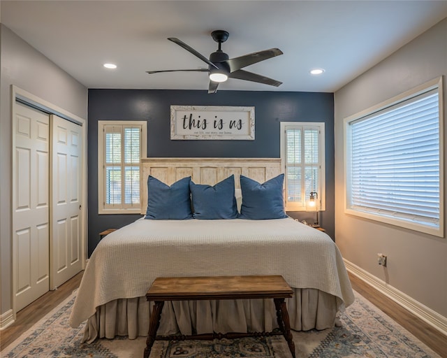 bedroom with hardwood / wood-style flooring, ceiling fan, and a closet