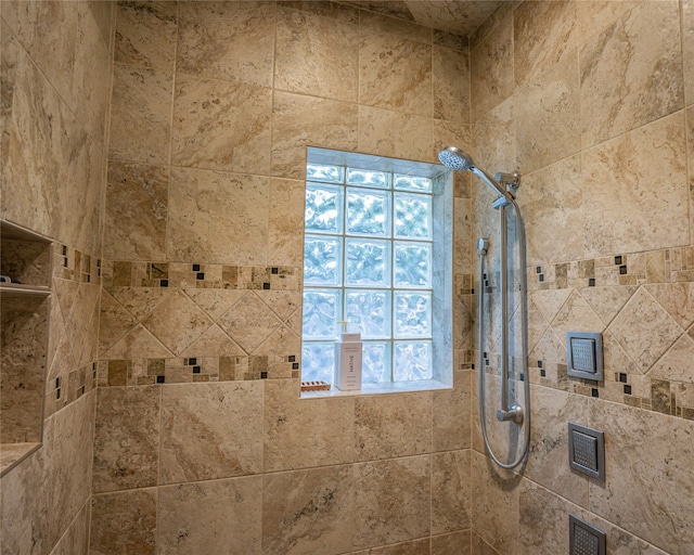 bathroom with tiled shower