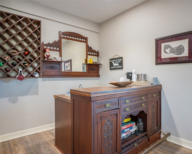 bar with dark hardwood / wood-style flooring